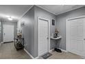 Hallway featuring neutral paint, doors, and tile floors, with table and decorations at 434 Ironside Trail Dr, Groveland, FL 34736