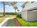 Exterior view of property showing well maintained lawn with water view at 4505 Ring Neck Rd # B-1, Orlando, FL 32808