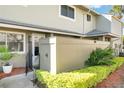 Exterior view of unit entrance with partial fence, shrubs and walkway at 4505 Ring Neck Rd # B-1, Orlando, FL 32808