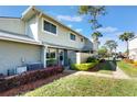 Exterior view of property showing lawn, shrubs and tidy walkway to unit at 4505 Ring Neck Rd # B-1, Orlando, FL 32808