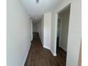 Long hallway with wood-look flooring and neutral paint, bright and inviting at 493 E Palmetto Ave, Longwood, FL 32750