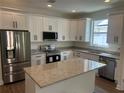 Modern kitchen features stainless appliances, granite countertops, and island at 493 E Palmetto Ave, Longwood, FL 32750