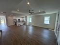 Open-concept living room with wood floors, recessed lighting, and kitchen view at 493 E Palmetto Ave, Longwood, FL 32750
