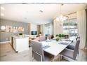 Bright dining area featuring a modern chandelier and seamless connection to outdoor patio space at 4962 Windermere Ave, Kissimmee, FL 34746