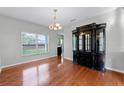 Dining room with hardwood floors, chandelier lighting, and view of the backyard at 5456 Crepe Myrtle Cir, Kissimmee, FL 34758