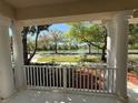 Scenic view from the covered porch overlooking a tranquil neighborhood pond at 6475 New Independence Pkwy, Winter Garden, FL 34787