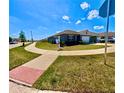 Single-Gathering home featuring a well-maintained lawn and landscaping in a suburban setting, showcasing curb appeal at 992 Serchio St, Haines City, FL 33844