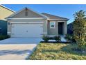 Inviting single-story home featuring a two-car garage and a well-manicured front yard at 994 King Parc Rd, Orange City, FL 32763