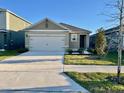Well-maintained single-story home featuring a two-car garage and a neat front lawn at 994 King Parc Rd, Orange City, FL 32763