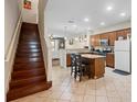 Bright kitchen features a central island with bar seating and stainless steel appliances at 10785 Corsican St # 3, Orlando, FL 32824