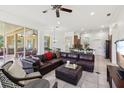 Inviting living room featuring a large leather sectional, tile flooring, and an open floor plan at 11108 Rockport St, Orlando, FL 32836