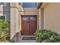 Inviting front door with decorative glass panels and elegant exterior lighting at 122 Carmel Bay Dr, Sanford, FL 32771