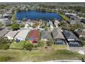 An aerial view of homes backing to a scenic lake, showcasing the desirable neighborhood and tranquil setting at 13850 Mirror Lake Dr, Orlando, FL 32828