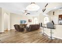 Bright, open-concept living area with wood floors and bar seating adjacent to the kitchen at 158 Cedar Springs Cir, Debary, FL 32713