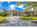 Attractive home features an elegant circular driveway leading to an attached two-car garage at 1649 Kersley Cir, Lake Mary, FL 32746