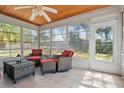 Bright sunroom with tiled floors, many windows and wicker furniture at 1740 Efland Ter, Deltona, FL 32738