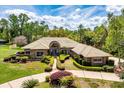 Stunning brick home with a tan tile roof and meticulously manicured landscaping at 2733 Deer Berry Ct, Longwood, FL 32779