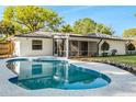 Inviting backyard pool featuring a screened lanai and meticulously maintained landscaping at 2952 Ashwood Ct, Apopka, FL 32703
