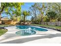Sparkling backyard pool surrounded by lush landscaping and a privacy fence at 2952 Ashwood Ct, Apopka, FL 32703