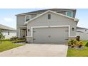 Two-story home features gray stucco, stone accents, a gray garage door, and a well-manicured lawn at 3936 Fescue St, Clermont, FL 34714