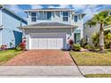 Charming two-story home boasts a brick driveway, tidy lawn, and a majestic palm tree accenting the facade at 3964 Lightning Ct, Sanford, FL 32773