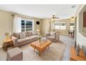 Cozy living room featuring neutral tones, natural light, and comfortable seating, perfect for relaxation and entertaining at 46 Morning Glory Dr, Debary, FL 32713