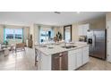 Open concept kitchen with a center island, stainless steel appliances, and an adjacent dining area overlooking the backyard at 5223 Ligonberry St, Lakeland, FL 33811