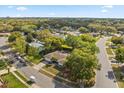 Aerial view of the house in a neighborhood, showcasing its setting amongst mature trees at 520 Balsawood Ct, Altamonte Springs, FL 32714