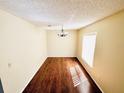 Dining room featuring wood floors, a modern chandelier, and natural light from a window at 527 Huxford Ct, Lake Mary, FL 32746