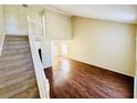 Bright living room showcasing wood floors and a staircase leading to the second floor at 527 Huxford Ct, Lake Mary, FL 32746