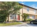 Townhouse with a front yard featuring mature trees and a well-manicured lawn at 7417 Wynnewood Sq # 174, Winter Park, FL 32792