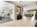 Inviting foyer with decorative mirror and lighting fixtures, offering a glimpse into the adjacent dining and living areas at 7419 Gathering Ct, Reunion, FL 34747