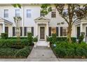 Inviting townhome entrance with a well-kept lawn, classic black shutters, and a welcoming front door at 906 Blue Sage St, Kissimmee, FL 34747