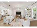 Bright living area with a chandelier, plush seating, and an open concept layout leading to the kitchen at 906 Blue Sage St, Kissimmee, FL 34747