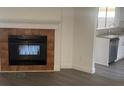 Cozy living room featuring a tiled fireplace and vinyl floors next to the kitchen at 1059 Manigan Ave, Oviedo, FL 32765