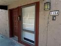 Close up exterior showing the front door next to a window and house number at 1154 Calle Del Norte # E, Casselberry, FL 32707