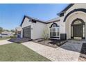 View of the front door with brick paver walkway, with meticulous landscaping at 116 Brookshire Dr, Lake Wales, FL 33898