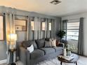 Cozy living room showcasing a stylish gray sofa, soft lighting, and elegant decor with serene gray wall tones at 1246 Rhodes Ct, Orlando, FL 32808