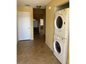 Hallway featuring a laundry area with stacked washer and dryer, plus stairs at 1270 Westside Dr, Winter Garden, FL 34787