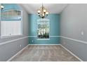 This dining room boasts gray walls and a large window allowing lots of natural light at 1601 Carillon Park Dr, Oviedo, FL 32765