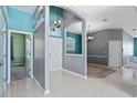 Bright foyer with tile flooring, gray walls, and a decorative archway leads into the living spaces at 1601 Carillon Park Dr, Oviedo, FL 32765