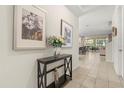 Inviting foyer with neutral tones, tile flooring, stylish decor, and views of the open floor plan beyond at 1832 Sandy Park Trl, Kissimmee, FL 34747