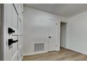 Bright hallway featuring new flooring, white walls, and modern hardware at 202 Ramsbury Ct, Longwood, FL 32779