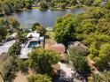 Aerial view of home highlighting pool, roof and surrounding trees and nearby lake at 2316 Marlboro St, Orlando, FL 32806