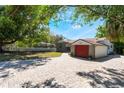 Exterior shot of the home showcasing brick driveway and colorful garage door at 2316 Marlboro St, Orlando, FL 32806