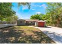 Charming front yard of home showing brick driveway, colorful garage door and well-manicured lawn at 2316 Marlboro St, Orlando, FL 32806