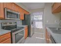 Updated kitchen featuring stainless steel appliances, sleek countertops, and wood cabinets at 2742 Rio Grande Trl, Kissimmee, FL 34741