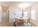 Inviting dining room with a modern table, stylish chairs, and ample natural light from the windows at 2833 Attwater Loop, Winter Haven, FL 33884