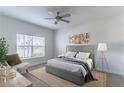 Serene main bedroom featuring a comfortable bed, large window, and chic decor for a relaxing retreat at 2833 Attwater Loop, Winter Haven, FL 33884