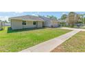 Beautiful single-story house with lush green grass and a paved driveway leading to an attached two-car garage at 323 Shadow Oak Dr, Casselberry, FL 32707